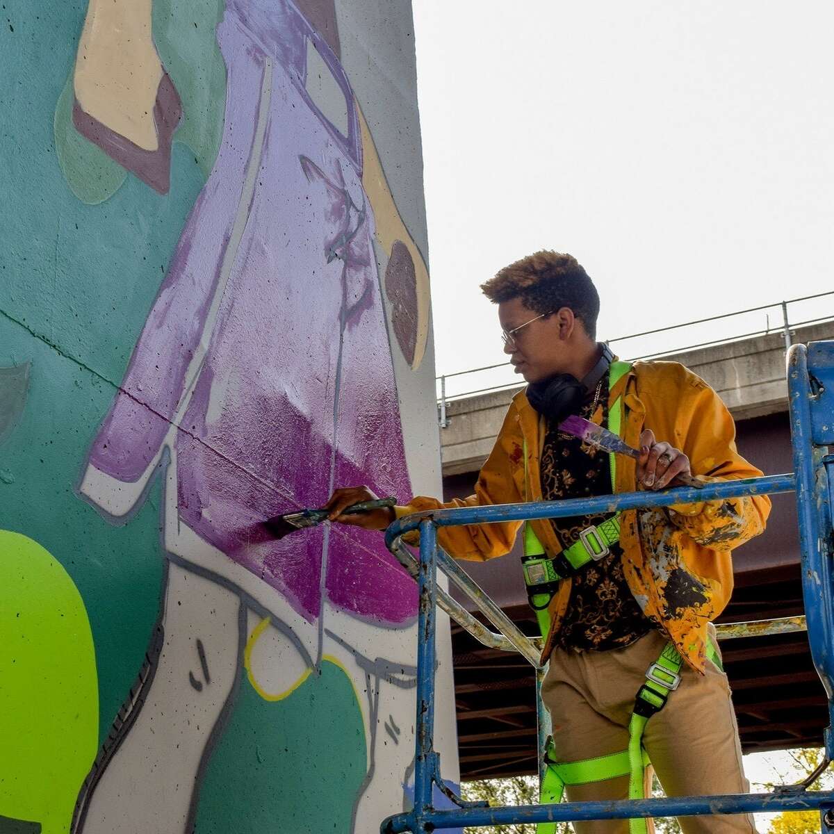  Jade Warrick, artist and founder of Amplified Voices NY, works on one of her murals.