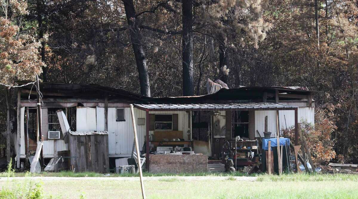 The remains of a mobile home is seen after a fire started in the home and ignited the trees and brush behind it, destroying the structure and an acre of surrounding property on July 29 in Splendora. Montgomery County Commissioners extended the county’s burn ban Tuesday as Fire Marshal Jimmy Williams urged residents to stop burning leaves and debris as drought conditions approach record levels.