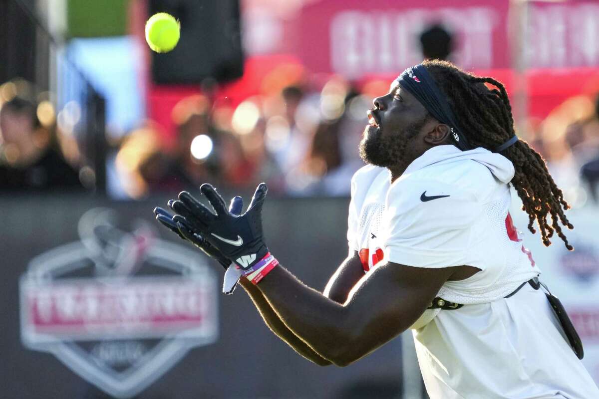 Houston Texans defensive back Tavierre Thomas reaches out to catch a tennis ball during a drill at an NFL training camp Tuesday, Aug. 2, 2022, in Houston.