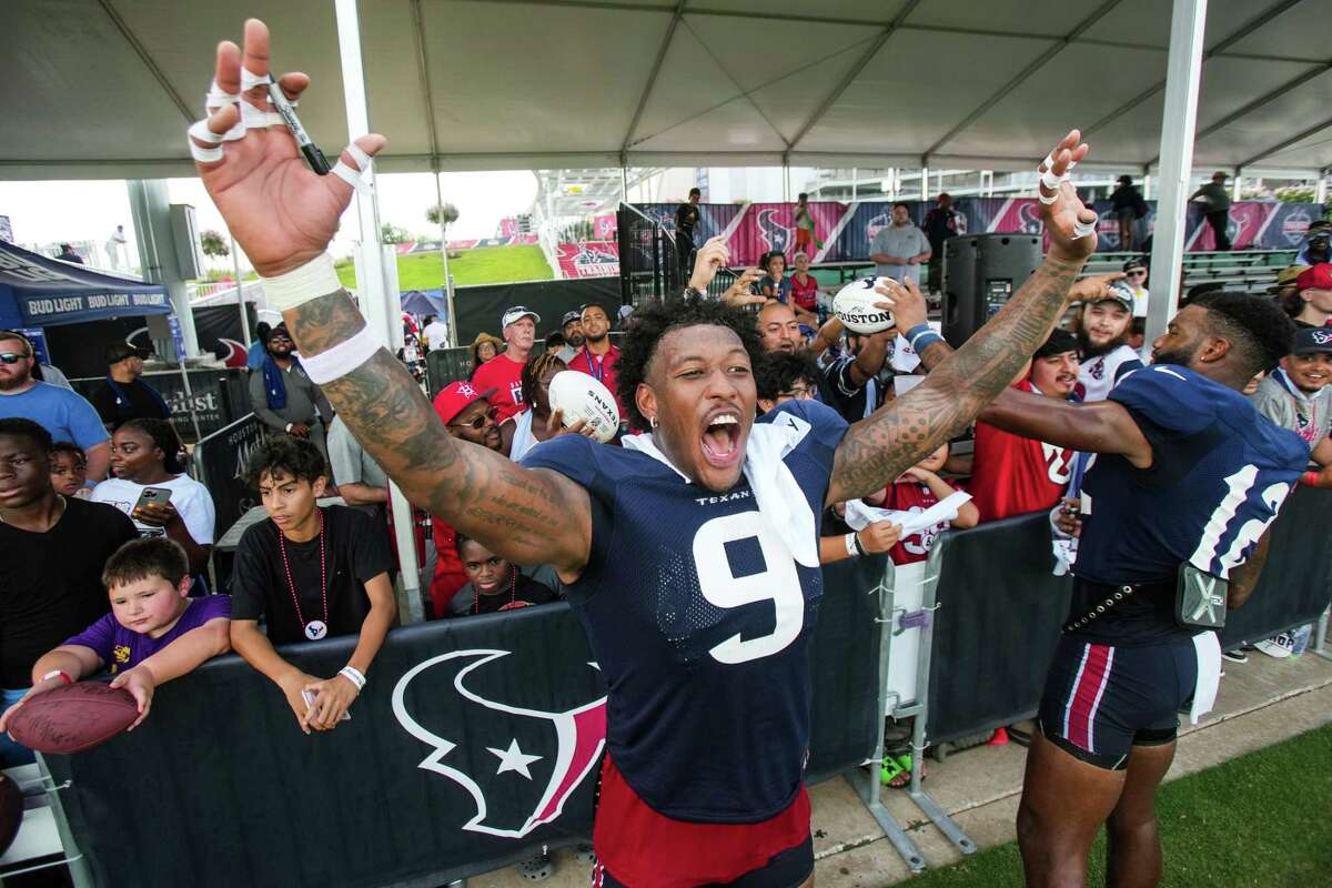 Houston Texans tight end Brevin Jordan (9) yells out jokingly for teammate Roy Lopez to come sign autographs during an NFL training camp Tuesday, Aug. 2, 2022, in Houston.
