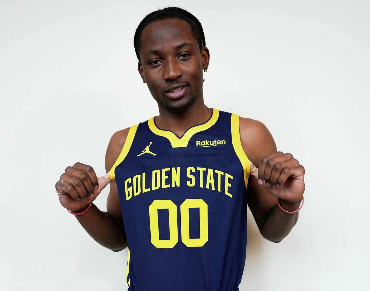 Warriors forward Jonathan Kuminga models the new Statement Edition jersey that Golden State revealed on Tuesday, Aug. 2, 2022.