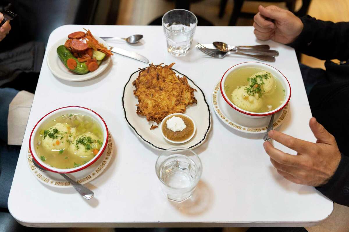 A couple sits down to eat matzo ball soup at Saul’s Restaurant and Delicatessen in Berkeley.