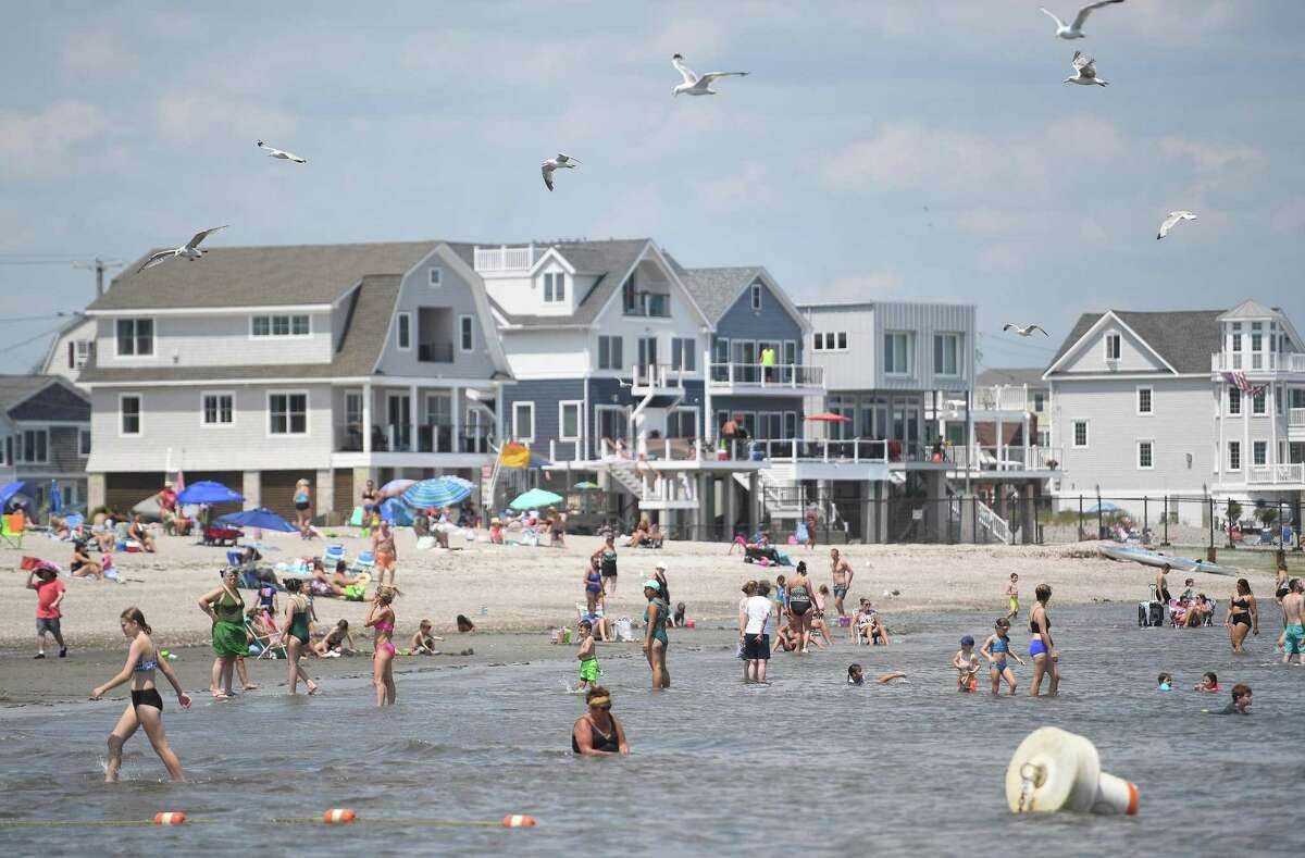 Crowds beat the heat with a dip in the Sound at Silver Sands State Park in Milford, Conn. on Tuesday, July 19, 2022. Temperatures are expected to feel like 95 to 100 degrees Thursday and Friday this week, the National Weather Service said. Heat advisories have been issued for both days throughout the tri-state metro region.