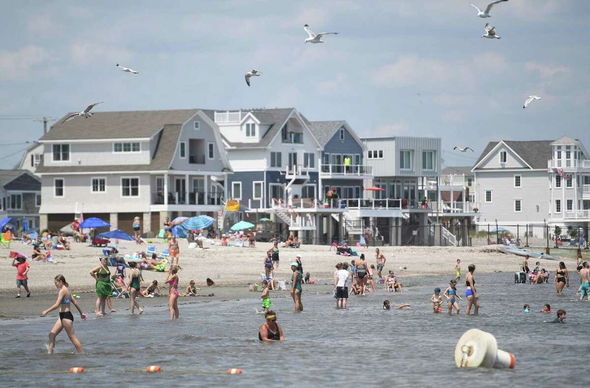 Crowds beat the heat with a dip in the Sound at Silver Sands State Park in Milford, Conn. Heat advisories remain in place Monday and Tuesday, before a cold front is expected to move into the area later this week.