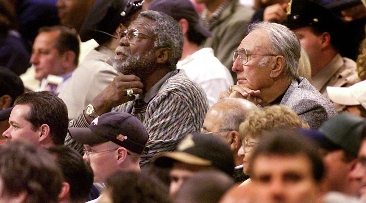 Boston Celtics Hall of Famers Bill Russell and Bob Cousy take in the action during a Celtics-76ers game in Boston on Apr. 7, 2000. The teammates won six NBA titles together.