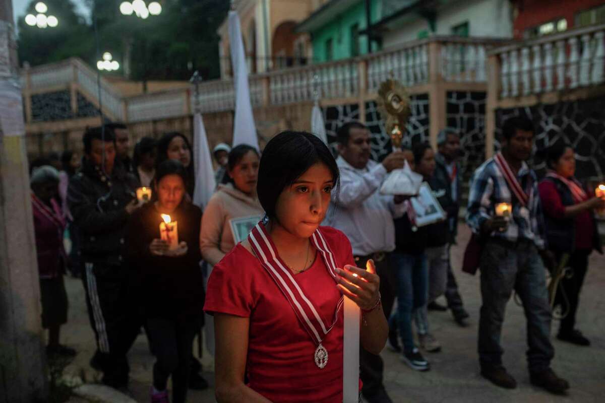 Residents in San Marcos Atexquilapan, Veracruz state, Mexico, late Thursday, June 30, 2022, hold a candlelight vigil to pray for three local teenagers in hopes they are not among the 53 migrants who died in a stifling, abandoned trailer in San Antonio, Texas. The deadliest smuggling attempt in U.S. history illustrated the limitations of Texas Gov. Greg Abbott's massive border apparatus after 53 migrants were found dead or dying in a tractor-trailer in San Antonio.