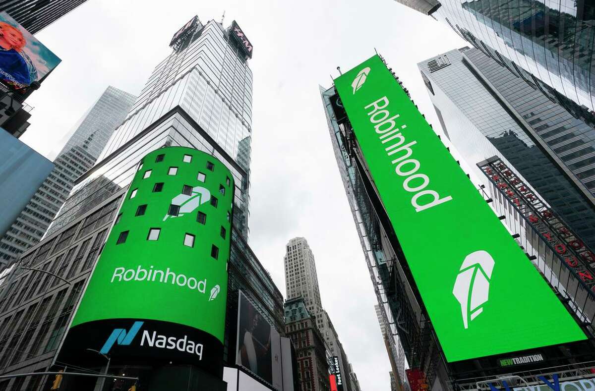 Electronic screens in New York’s Times Square announce the Robinhood IPO in 2021. Tuesday, the Menlo Park company announced layoffs.
