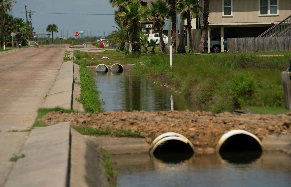 Drainage ditches run along a street on May 11, 2022, in Jamaica Beach on Galveston Island.