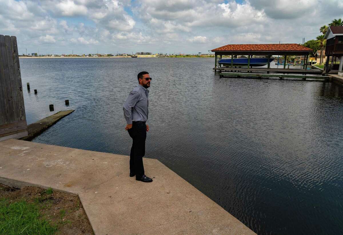 Brandon Cook, who works for the city of Galveston, points out the area where a pump station will be to hopefully keep water out of city streets on May 11, 2022, in Galveston.
