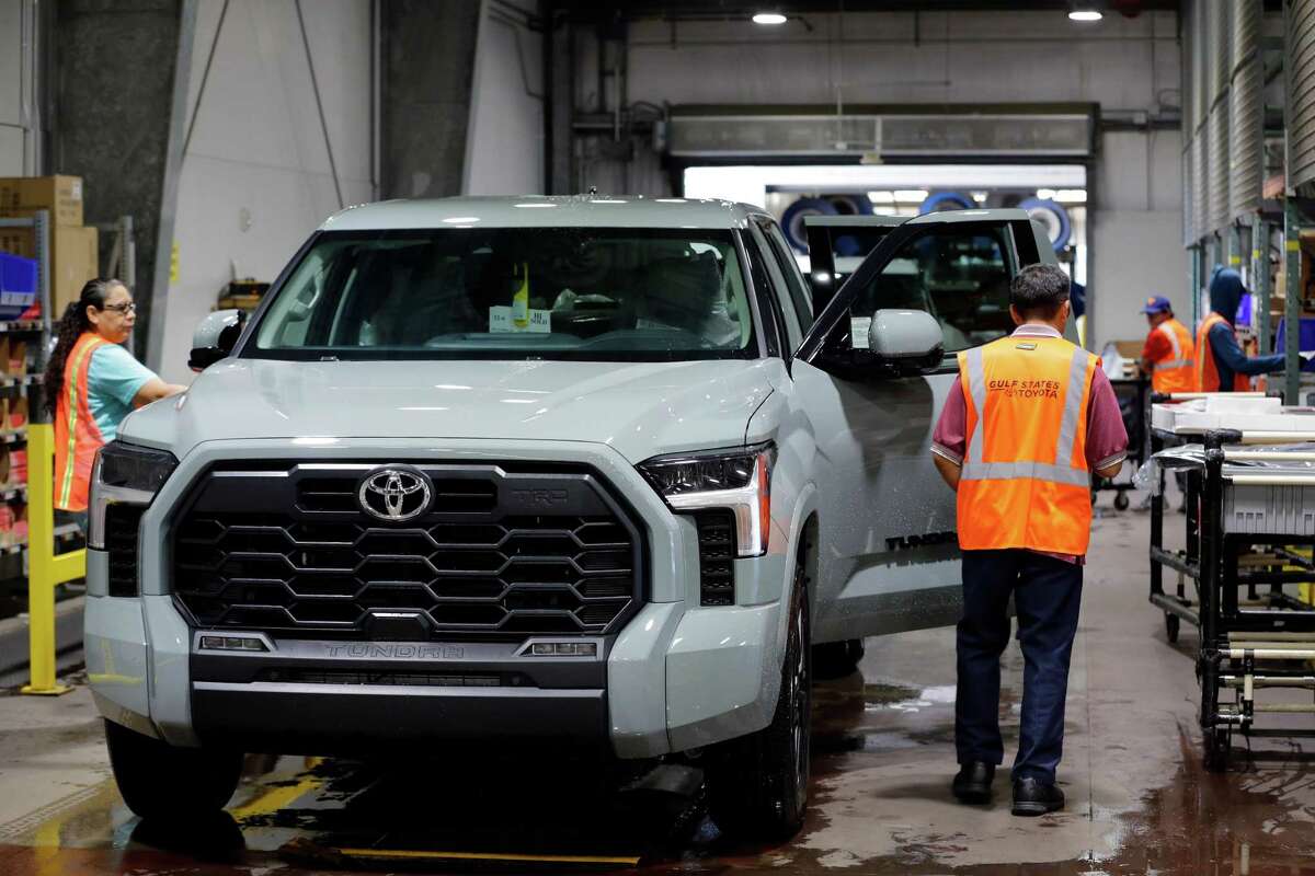 Toyota Tundra trucks get floor mats and other accessories at the Friedkin Group Gulf States Toyota processing facility before being shipped to dealerships.
