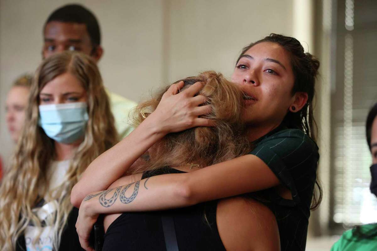 Daleen Garcia, 19, left, is hugged by her sister, Daisy, 25, after speaking in support of a resolution for abortion rights during a special meeting of the San Antonio City Council, Tuesday, Aug. 2, 2022