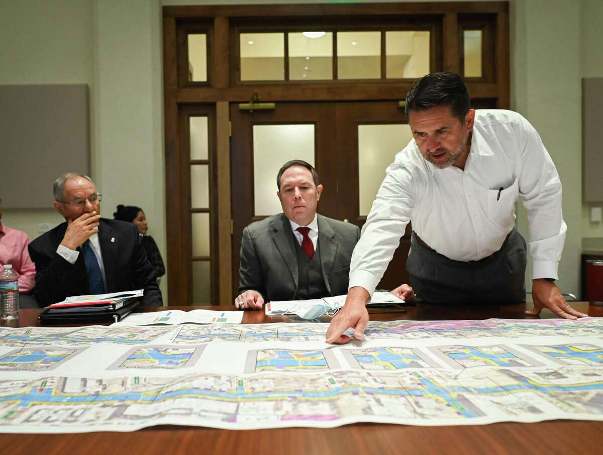 City officials Razi Hosseini, from left, Rod Sanchez and City Manager Erik Walsh discuss the redevelopment plan on Tuesday.