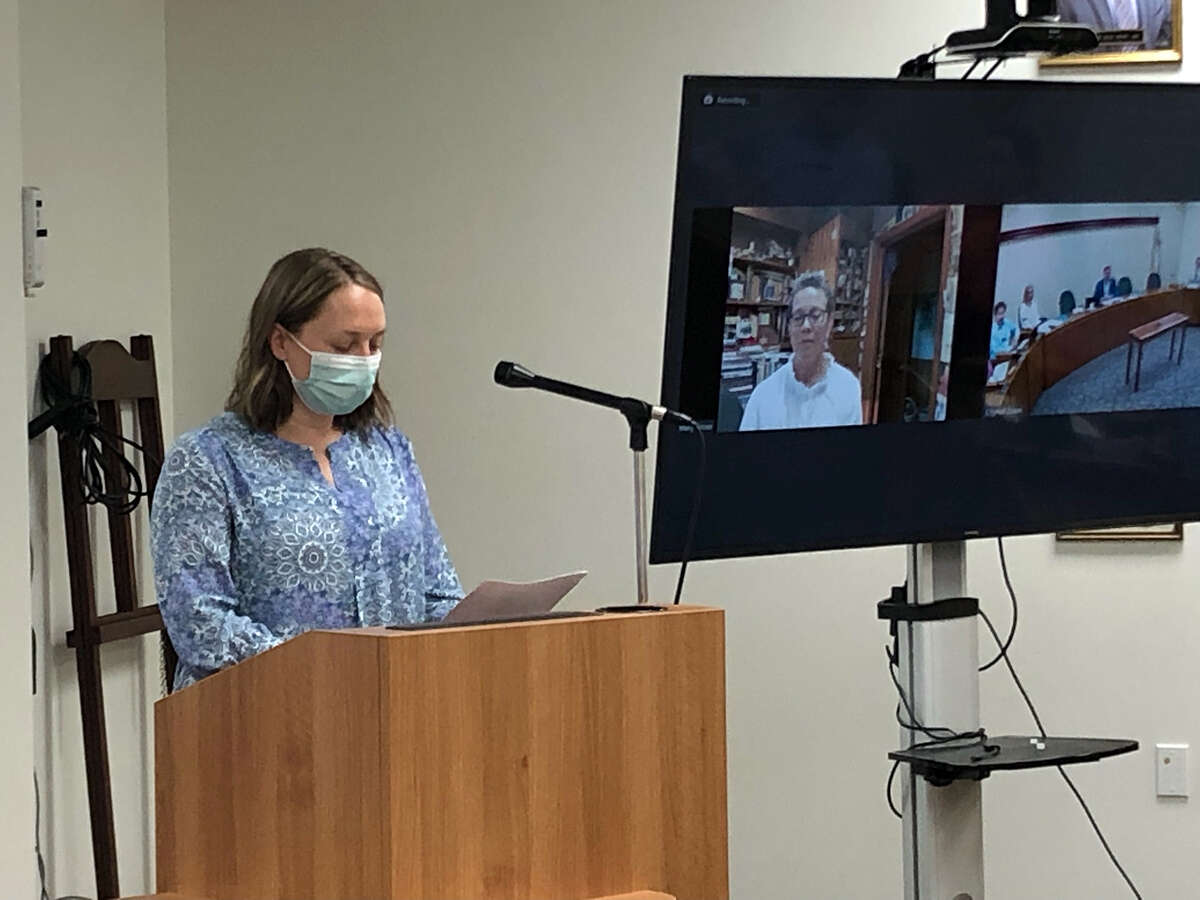 City Planner Emily Calderon, left, reads remarks about Mary Grose, who attended Tuesday's city council meeting virtually, on screen at right. Grose received the citizen's Excellence in Edwardsville honor. 