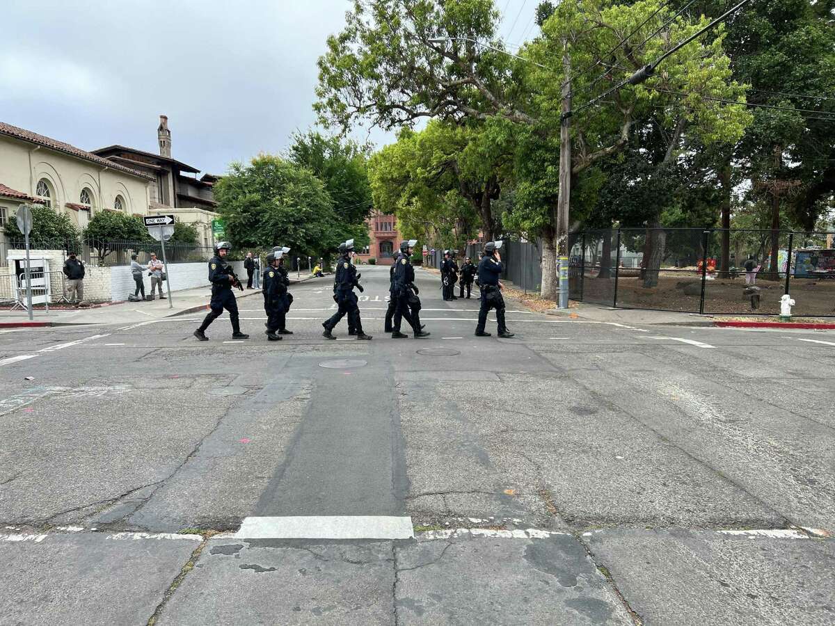 Police officers approaching People’s Park in Berkeley, Calif. as they prepared to remove people inside the park protesting the planned construction of student housing there.