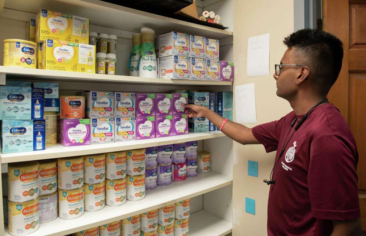 First year Albany Medical College student and volunteer Sid Sahai stocks infant formula on shelves at The Food Pantries for the Capital District on Tuesday, Aug. 2, 2022 in Albany, N.Y. The Food Pantries is organizing a task force to help low-income families acquire infant formula, which is still hard to find.