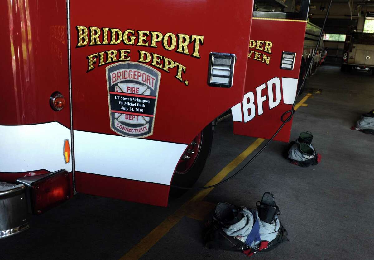 Bridgeport officials said a firefighter was hospitalized Tuesday night after falling through the second floor of a building while battling a blaze.