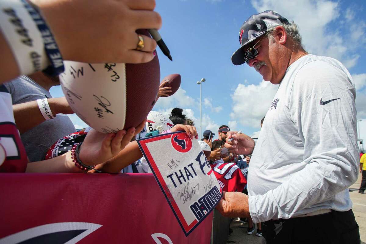 Houston Texans CEO Cal McNair signs autographs for fans during an NFL training camp Wednesday, Aug. 3, 2022, in Houston.