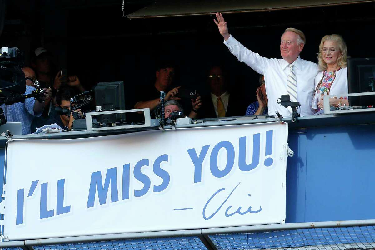 Los Angeles Dodgers announcer Vin Scully waves with his wife Sandra Hunt to fans after the team's 10th inning win against the Colorado Rockies September 25, 2016 at Dodger Stadium in Los Angeles.  (Luis Sinco/Los Angeles Times/TNS)