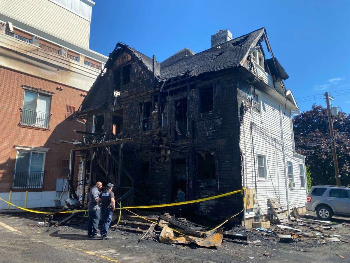 The heavily-damaged remains of a multi-family home near Cummings Park in Stamford, Conn. following a fire that broke out around 2 a.m. Wednesday, Aug. 3, 2022. Stamford officials said eight residents were displaced by the blaze.