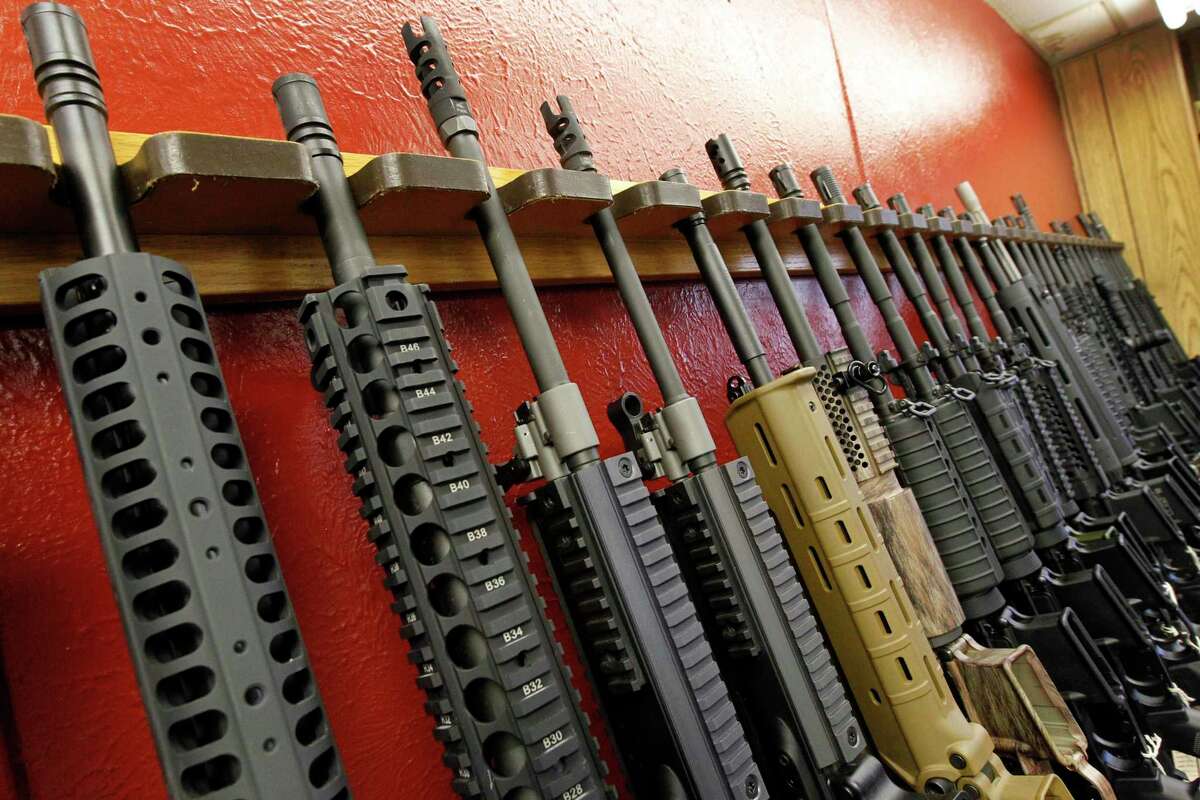 A row of rifles for sale is on display at a gun shop in Aurora, Colo., on July 20, 2012.