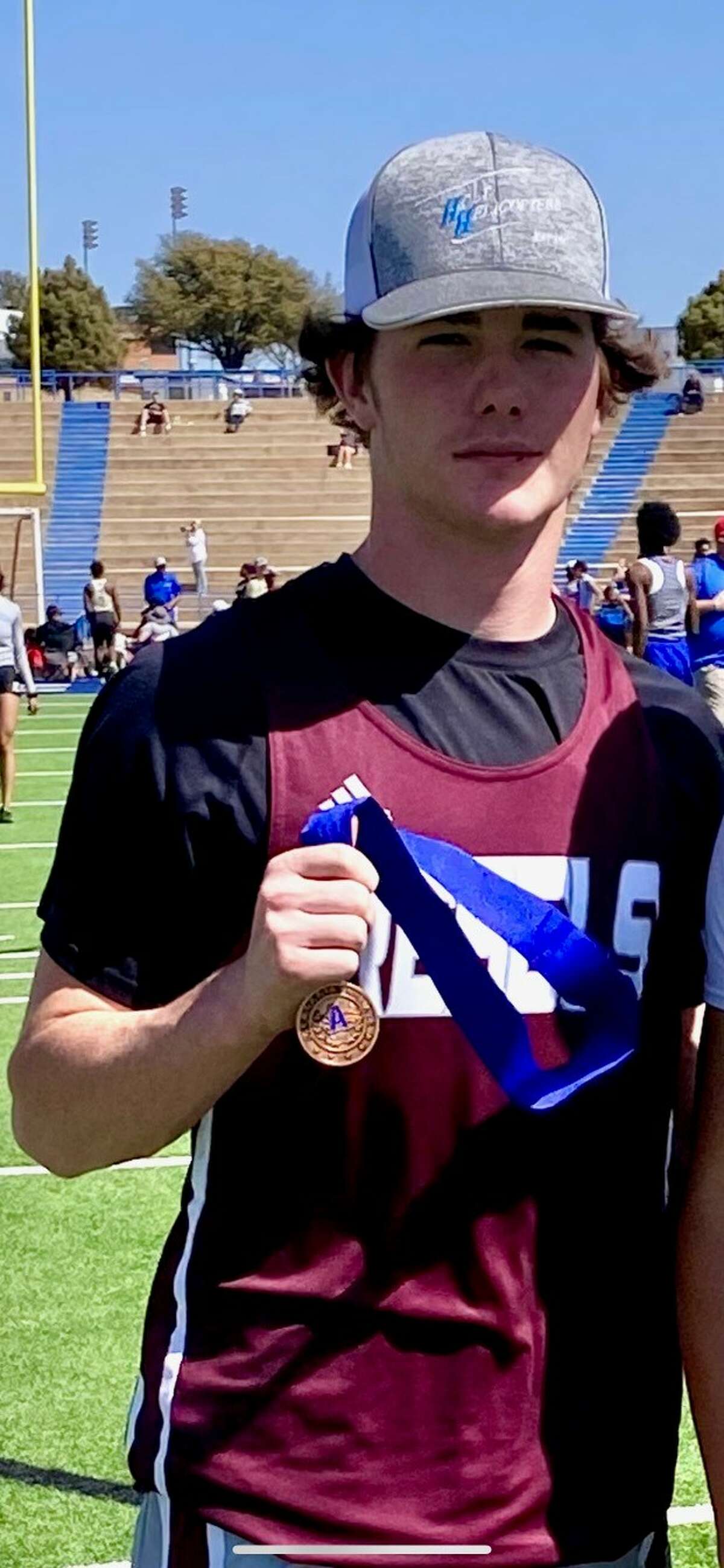 Legacy junior Caleb Hardy holds a medal after competing in the pole vault during his sophomore season. 