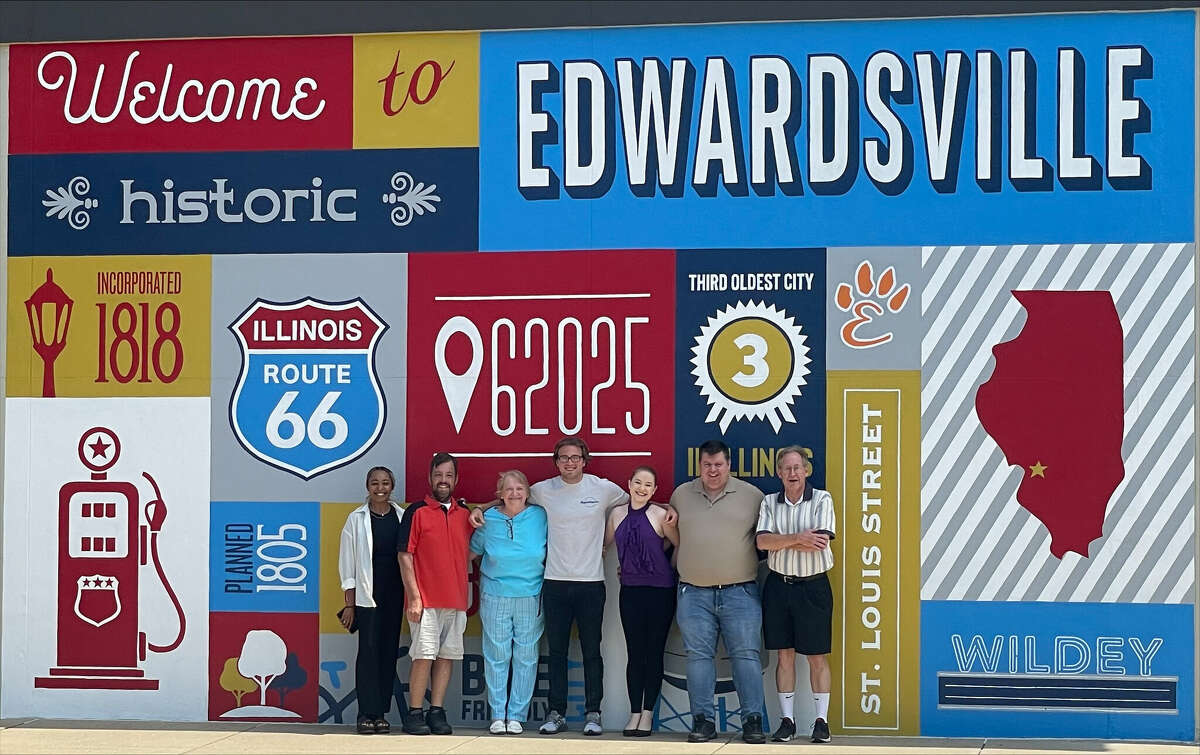 The Intelligencer staff poses in front of the Route 66 mural in downtown Edwardsville. Pictured is editor Brittany Johnson, sports editor Matt Kamp, customer service representative Mary Cox, reporter Billy Woods, reporter Julie Laakko-Swanson, reporter Charles Bolinger and reporter Scott Marion. 