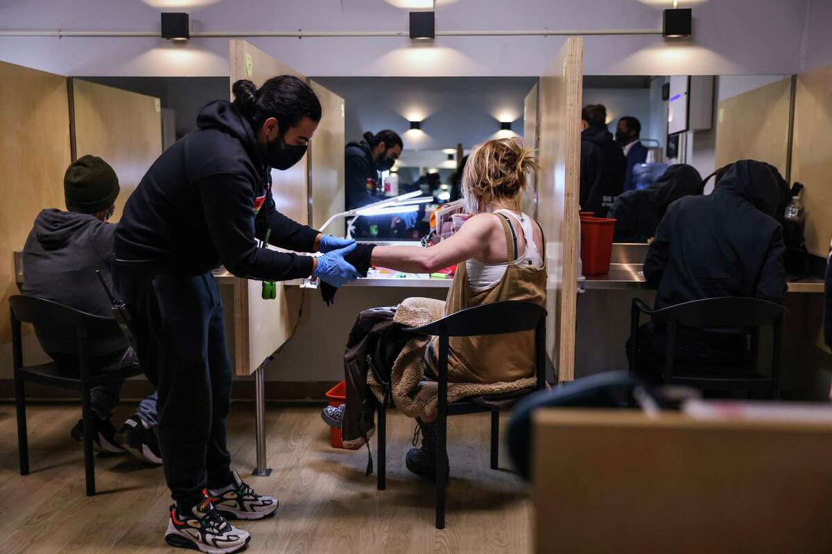 A staff member helps a client at OnPoint NYC, a supervised drug consumption site in New York. A bill that would allow similar sites to open in California is on Gov. Gavin Newsom’s desk.