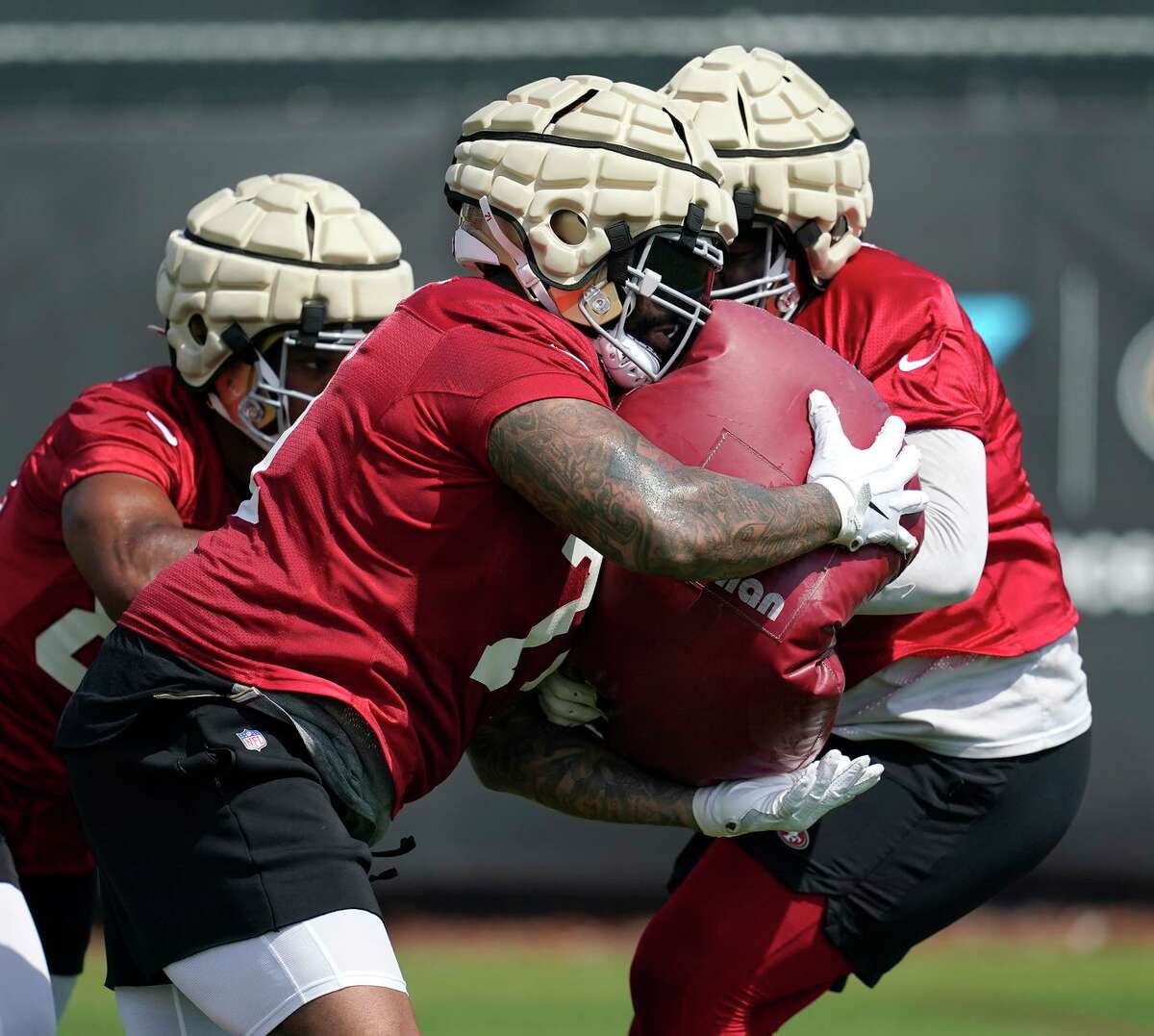 In 2021, 49ers tackle Trent Williams (middle) didn’t allow a sack and earned the highest grade given to a player (97.8) by Pro Football Focus since the site launched its grading system in 2006.