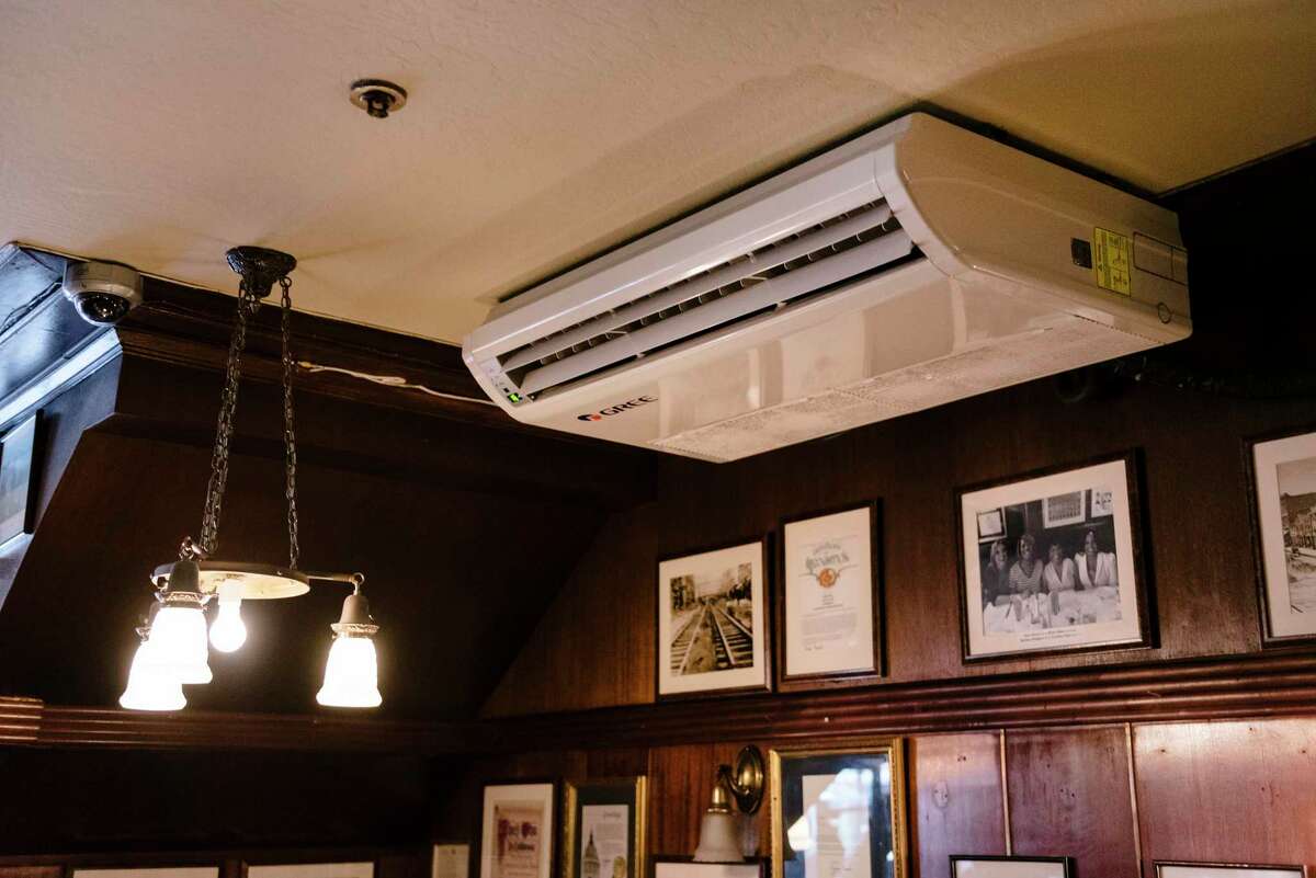 A new air filter is attached to the ceiling in the dining room at John's Grill in San Francisco.