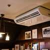 A new air filter is attached to the ceiling in the dining room at John's Grill in San Francisco, Calif, on Wednesday, September 30, 2020. Air filtration is one of many variables affecting how long aerosolized coronavirus particles stay in the air, experts say.