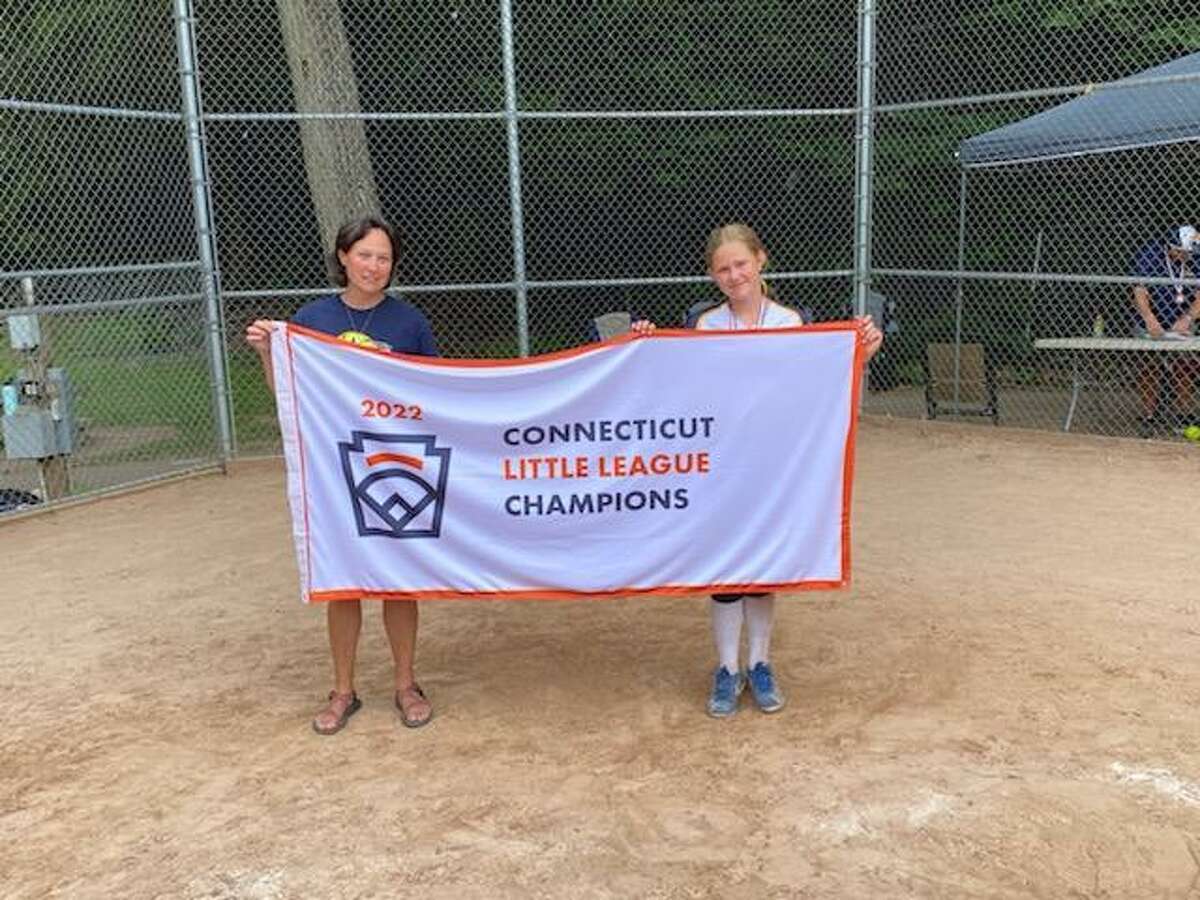 Donna Fagan, right, and her daughter Riley Fagan-Davis display the 2022 Connecticut Little League Softball state championship banner. Fagan-Davis is a part of the Milford team that will play in the Little League Softball World Series Aug. 9-15 in Greenville, N.C.