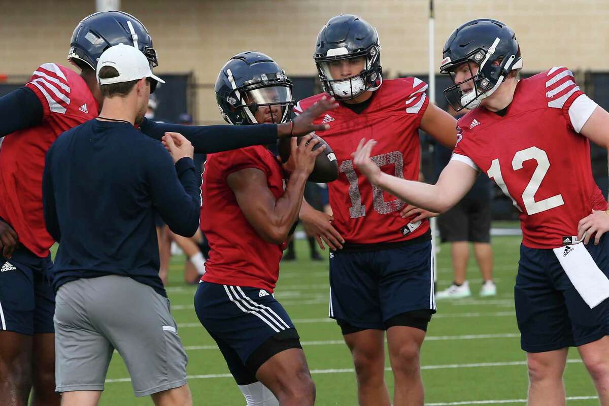 UTSA quarterback Frank Harris, second from left, runs a drill on the first day of Fall camp at the Roadrunner Athletics Center for Excellence, Wednesday, Aug. 3, 2022. Diego Tello, (10), and Eddie Lee Marburger, (12), join in.