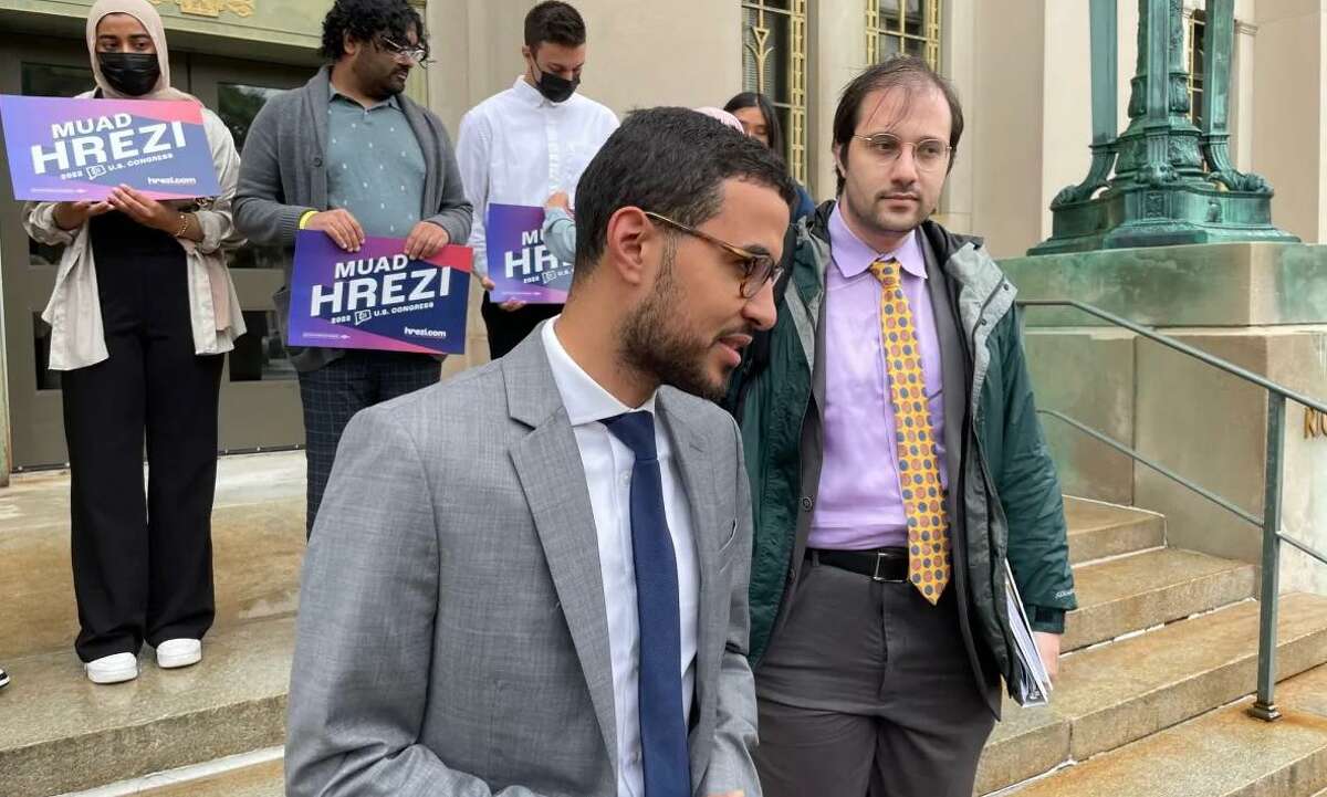Muad Hrezi talking to reporters outside Hartford Superior Court in June. At right is his lawyer, Alex Taubes.