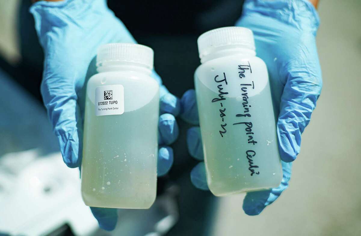 Two samples of wastewater are collected by the Houston Health Dept., one for them to test, the other for Rice University to test on Wednesday, July 20, 2022 in Houston. Houston was one of the first cities in the nation to post wastewater data to forecast COVID infection trends. It has been a consistently reliable indicator throughout the pandemic.