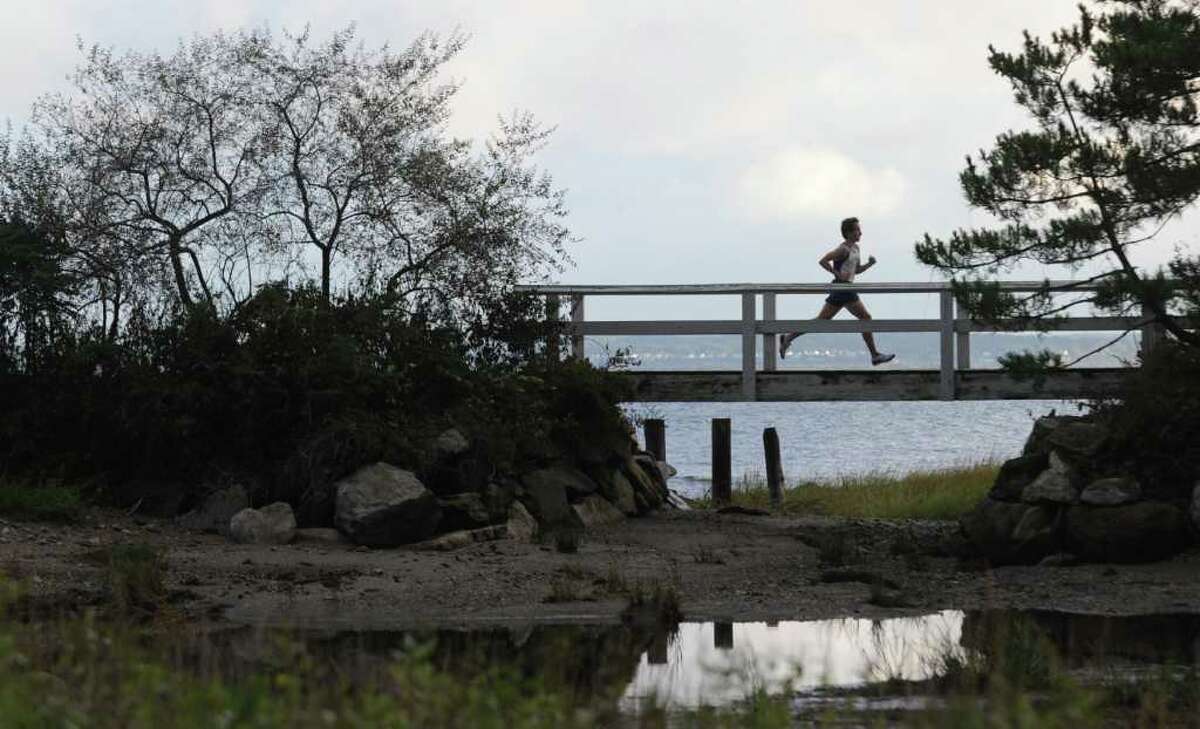 Westhill High School cross country runner Sam Lagasse crosses a bridge during race at Greenwich Point, Tuesday afternoon, Oct. 5th, 2010.