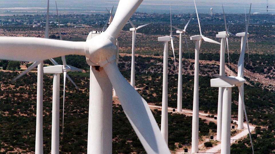 Sleek white wind turbines, 25 stories tall, rise from the plains of West Texas in Big Spring. Wind energy farms in West Texas and the Texas Panhandle often generate more electricity than its region can use, but insufficient transmission infrastructure prevent that energy from being shared with other parts of the state that could use it.