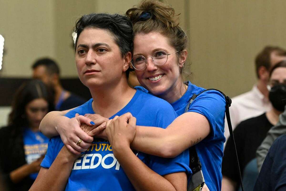 Iman Alsaden, Chief Medical Officer for Planned Parenthood Great Plains, and Kelsey Rhodes of Kansas City hug as they and Kansans for Constitutional Freedom supporters celebrate a victory at the polls Tuesday, August 2, 2022, at the Overland Park Convention Center, 6000 College Blvd. The group backed a "No" vote on the constitutional amendment, which if passed, removes the right to an abortion from the Kansas constitution. (Tammy Ljungblad/Kansas City Star/TNS)