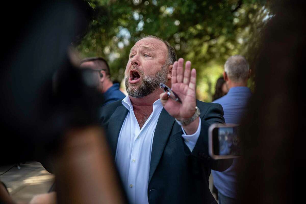 Alex Jones speaks to the media outside the 459th Civil District Court on Tuesday, Aug. 2, 2022 in Austin, TX. Neil Heslin and Scarlett Lewis are suing Alex Jones and InfoWars over his repeated claims that the 2012 shooting at Sandy Hook Elementary was a "false flag operation" conducted by the government.