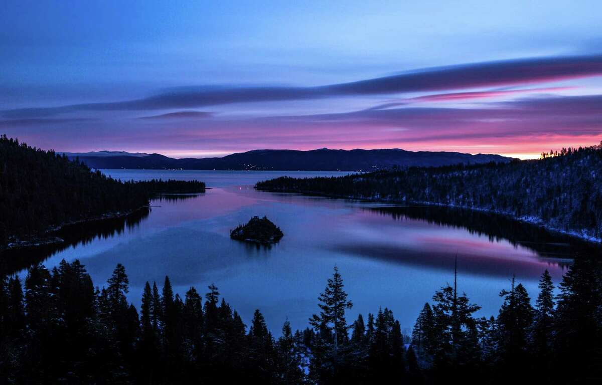 A dramatic sunrise colors the sky over Emerald Bay in South Lake Tahoe in 2018. Bursts of intense rain soaking Reno this week prompted a flood watch from the National Weather Service.