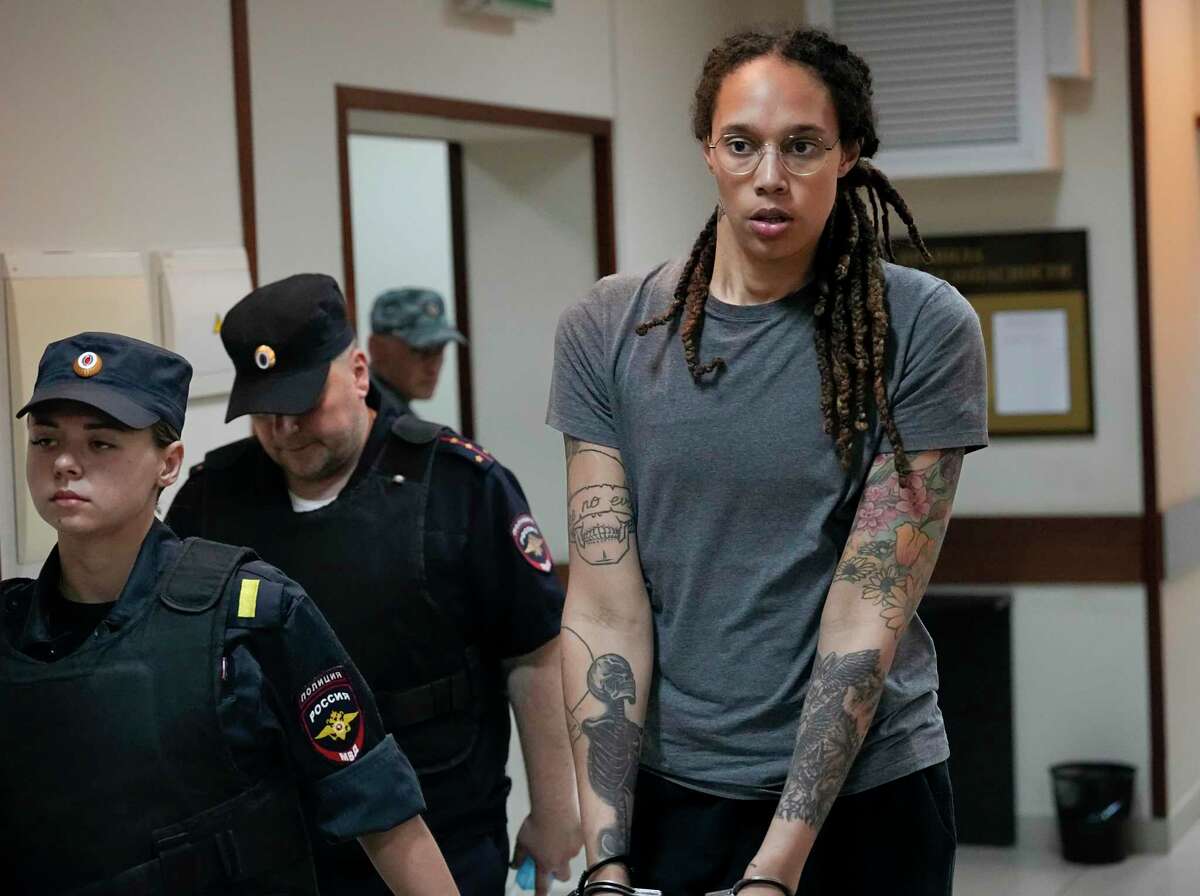 WNBA star and two-time Olympic gold medalist Brittney Griner is escorted from a courtroom after a hearing, in Khimki just outside Moscow, Russia, Thursday, Aug. 4, 2022. A judge in Russia has convicted American basketball star Brittney Griner of drug possession and smuggling and sentenced her to nine years in prison.\
