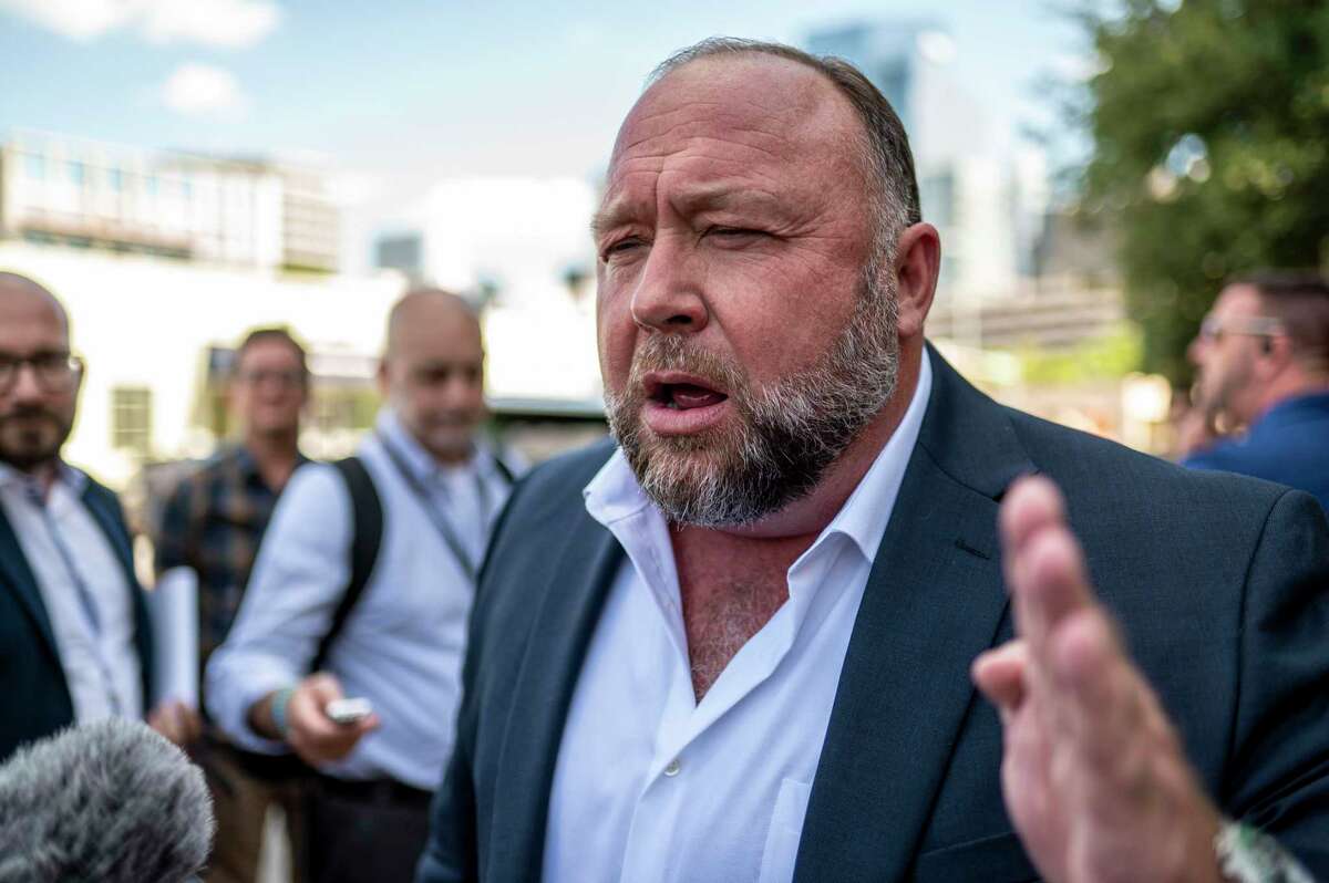 Alex Jones speaks to the media outside the 459th Civil District Court on Tuesday, Aug. 2, 2022 in Austin, Texas. Neil Heslin and Scarlett Lewis are suing Alex Jones and InfoWars over his repeated claims that the 2012 shooting at Sandy Hook Elementary was a “false flag operation” conducted by the government.