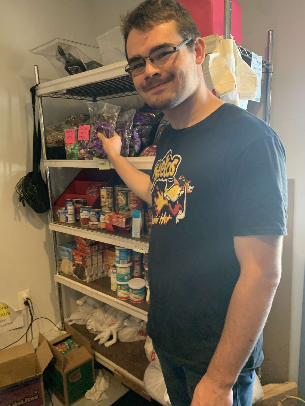 Manna Pantry in Big Rapids offers opportunities for special needs students to learn life and job skills through volunteering. volunteer Sean helps to repackage foods and shop for clients.