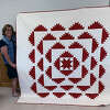 Marcia Cox won River Country Quilt Show's viewers' choice quilt award for her red-on-white "Delectable Mountains" quilt.