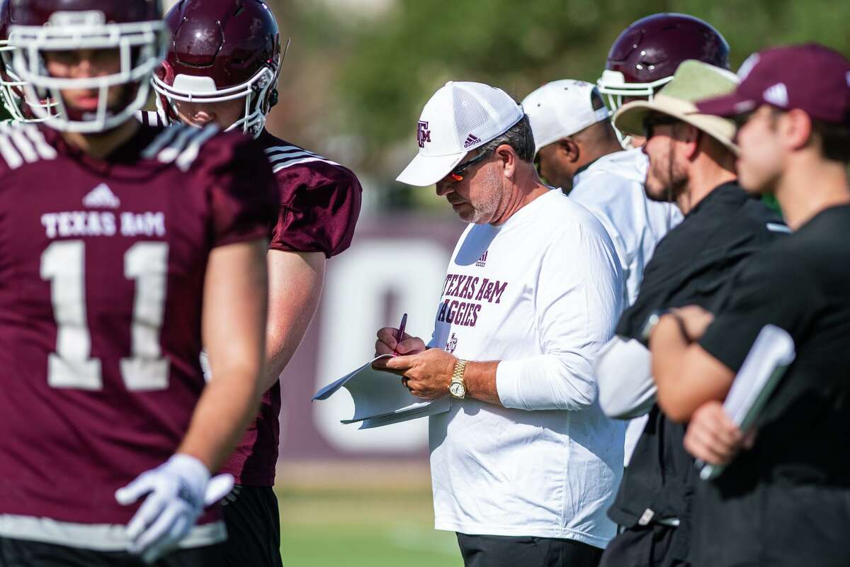Texas A&M football coach Jimbo Fisher takes notes as he runs drills during the first day of Texas A&M fall practice on Wednesday, Aug. 3 at the Coolidge Football Practice Fields on Texas A&M campus in College Station.