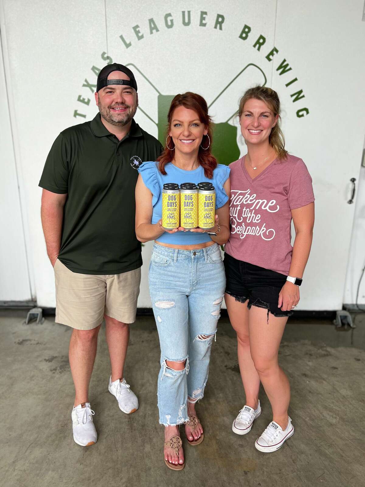 Houston Astros sideline reporter Julia Morales (center) has a collaboration beer with Nathan and Elise Rees of Texas Leaguer, called Dog Days.
