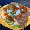 A birria taco at El Grullense Jal #5 crisping on the plancha.