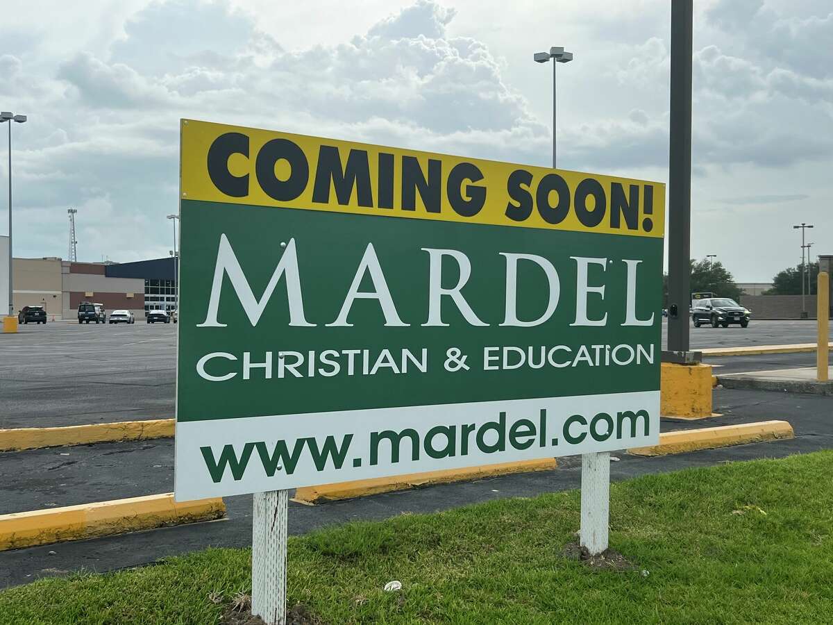 A sign indicating that a Mardel Christian bookstore is coming soon is up in front of the Texas 69 strip mall featuring Party City and Best Buy.