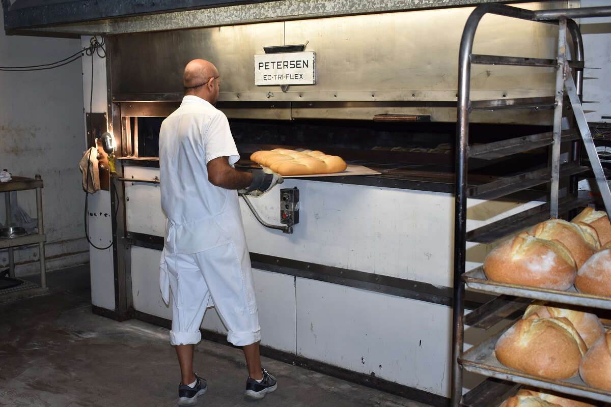 Baker Liborio Flores pulls a round from the oven at Bakerfield Pyrenees French Bakery, a 135-year-old California institution.