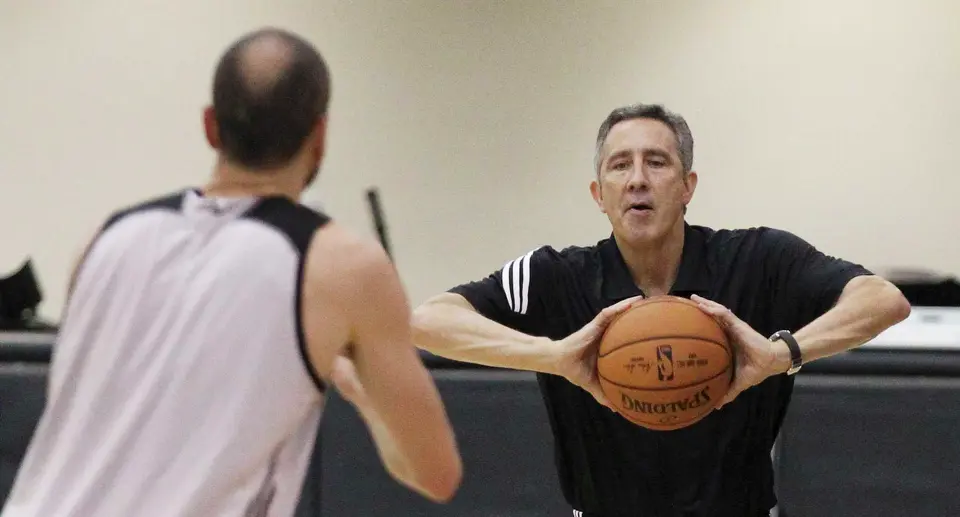 Spurs' assistant coach Chip Engelland passes the ball to veteran guard Manu Ginobili after the team's first official practice on Saturday, Sept. 27, 2014. (Kin Man Hui/San Antonio Express-News)