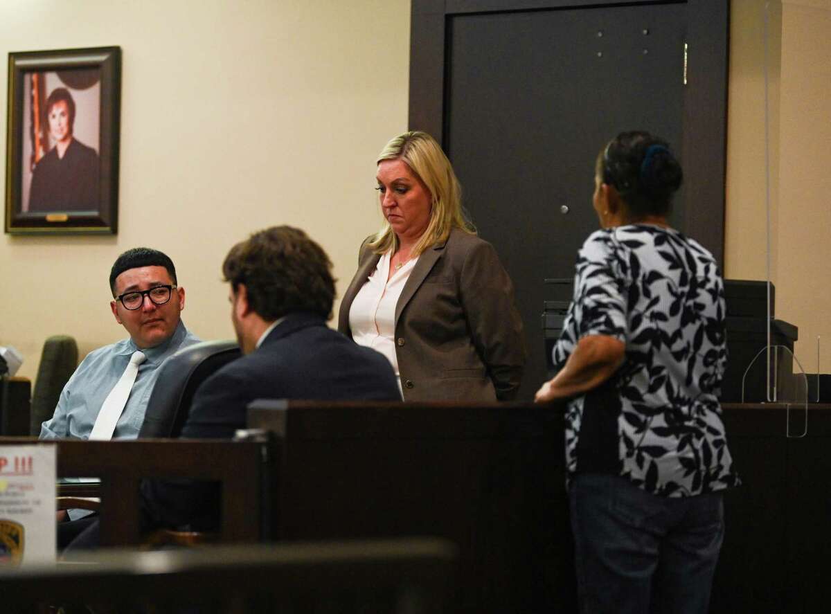Jorge Izquierdo, left, convicted of murder in the death of Cora Nickel, listens as his grandmother pleads to embrace him during the sentencing phase of his trial in 175th District Court on Thursday.